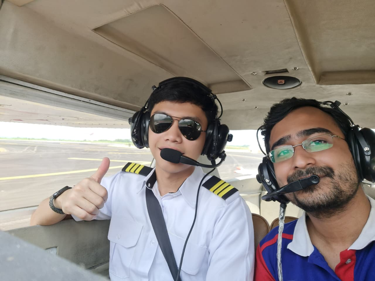 Student pilot giving a thumbs up in the cockpit